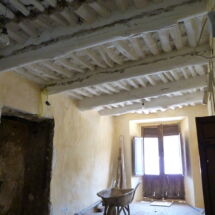 BEFORE: Old ceiling releasing dust and lime, narrow room, dampness in walls. Yasmin-lower-room-before